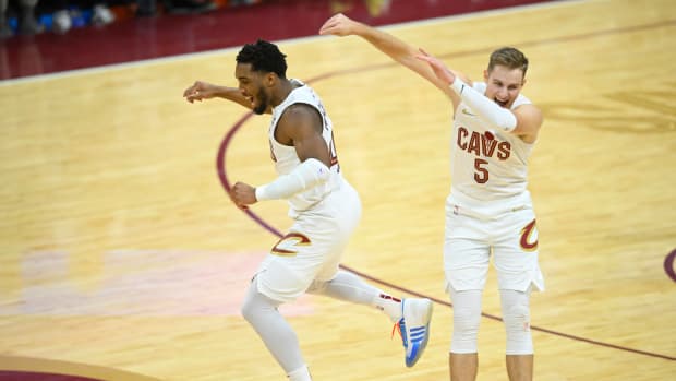 Dec 18, 2023; Cleveland, Ohio, USA; Cleveland Cavaliers guard Donovan Mitchell (45) and guard Sam Merrill (5) celebrate in overtime against the Houston Rockets at Rocket Mortgage FieldHouse.